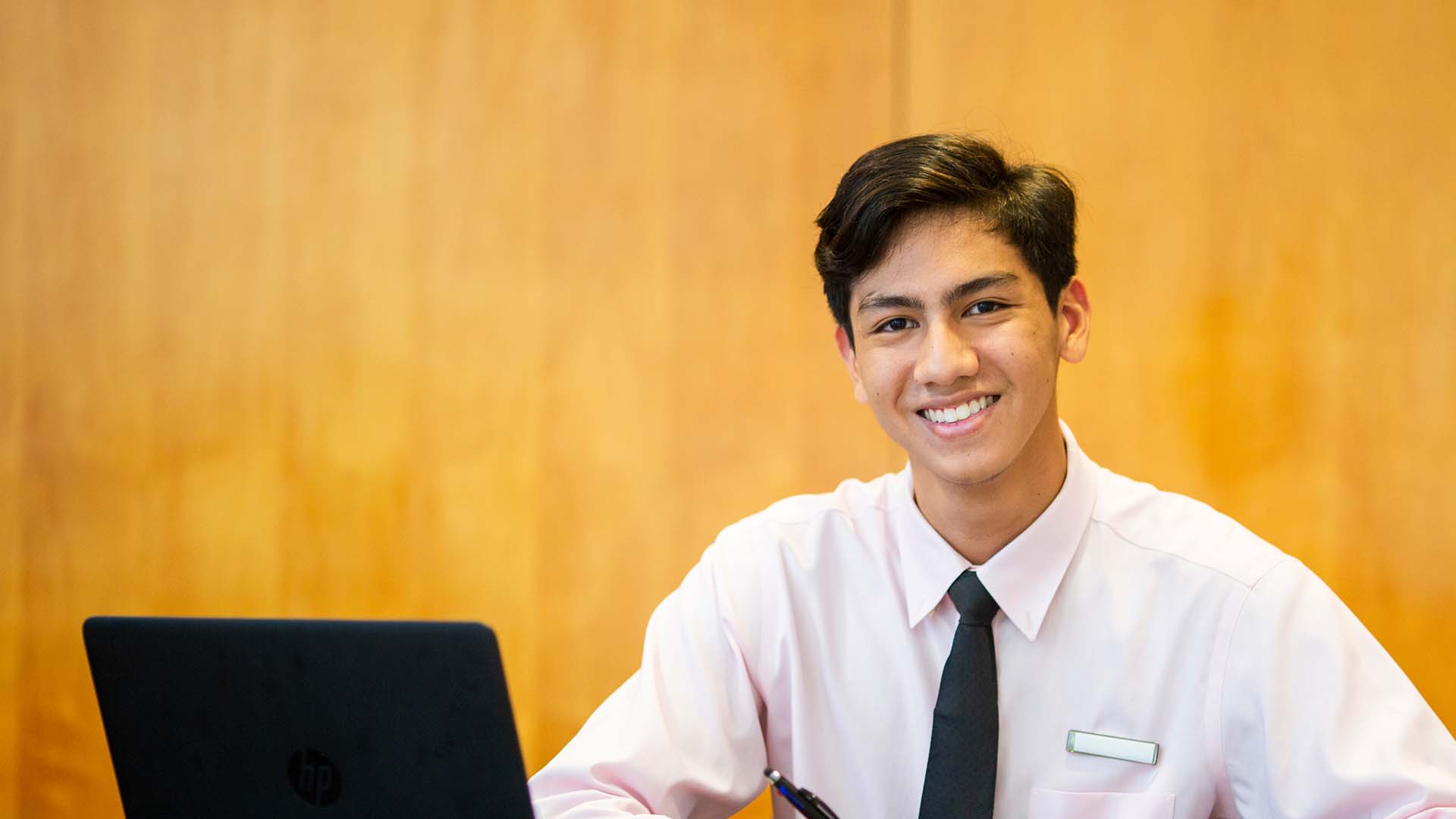 Guy Smiling while Using a Computer